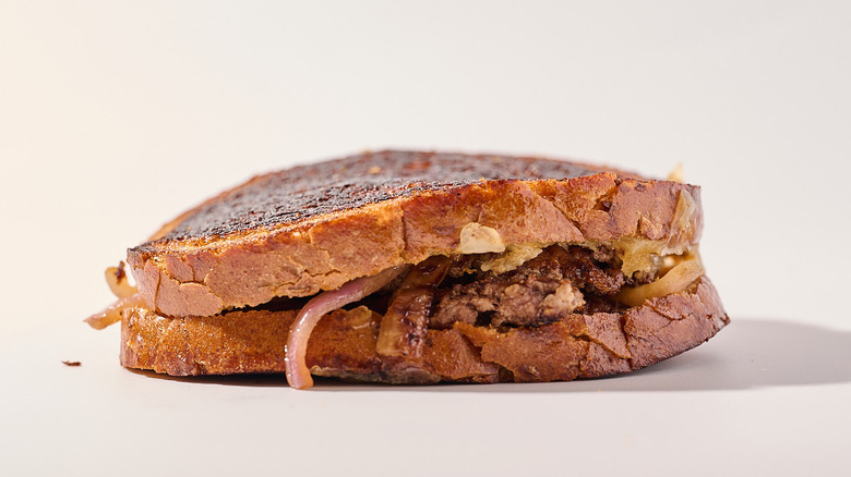 Swiss patty melt on a table