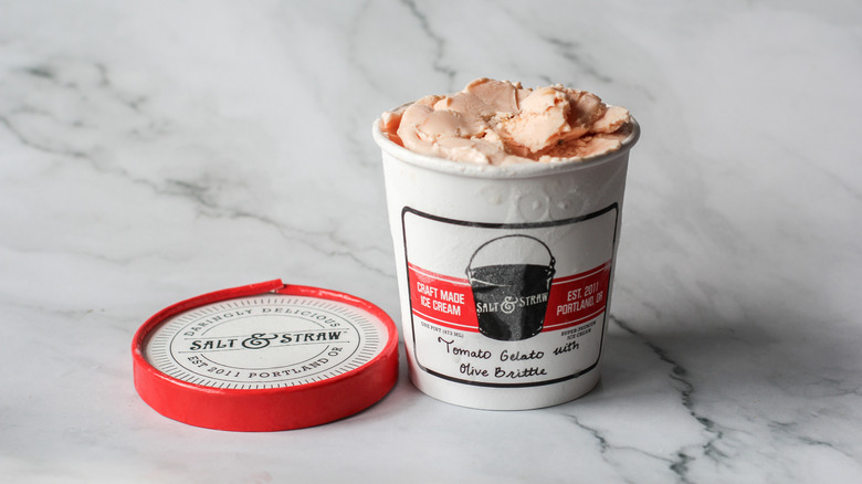 Tomato gelato pint on a marble surface