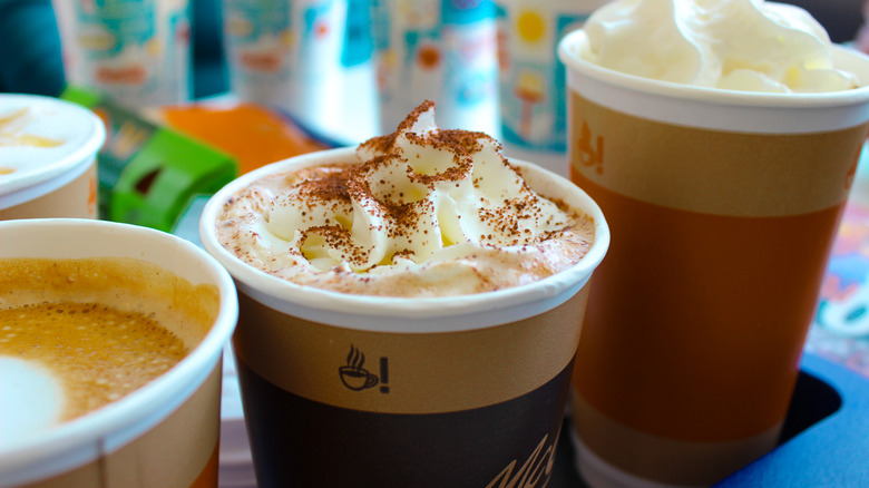 close up of coffee cups from McDonalds with whipped cream on top