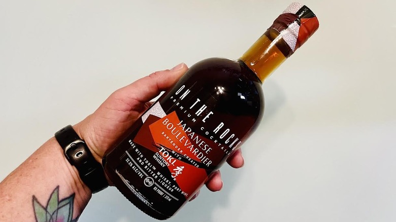 Hand holding bottle of On The Rocks Japanese Boulevardier