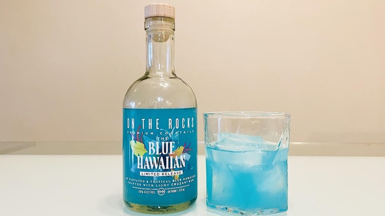 Bottle and glass of On The Rocks Blue Hawaiian