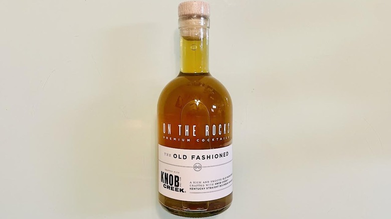 Bottle of On The Rocks Old Fashioned lying on table