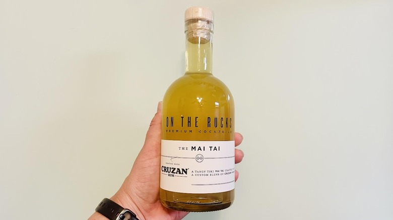 Hand holding bottle of On The Rocks Mai Tai