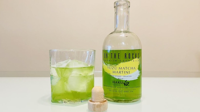 Bottle and glass of On The Rocks Yuzu Matcha Martini