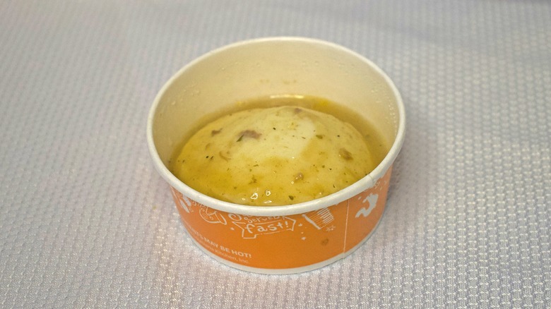 A single serving of mashed potatoes with gravy.