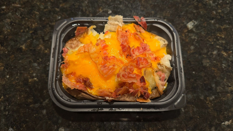 Wendy's Bacon Cheese Baked Potato in black to-go container