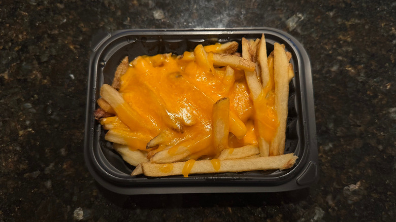 Wendy's Cheese Fries in black to-go container