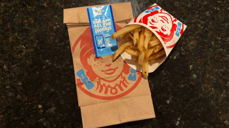 Sleeve of Wendy's french fries resting on to-go baggie