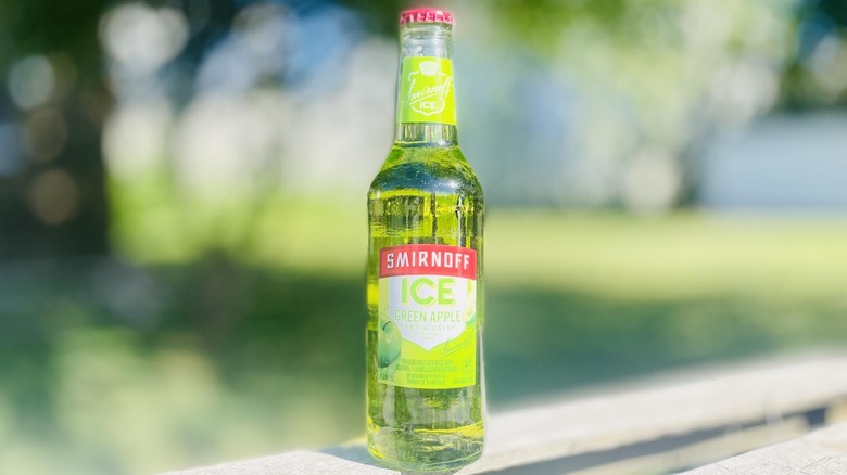 Bottle of Smirnoff Ice Green Apple on outdoor deck