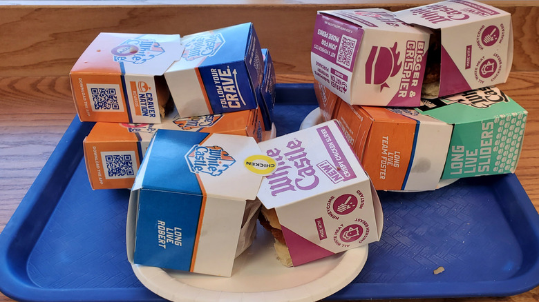 A pile of of White Castle sliders on a blue tray