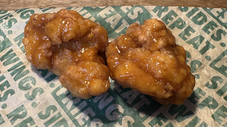 Two Hawaiian boneless wings on Wingstop food paper