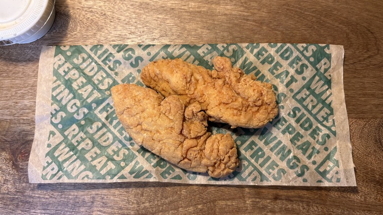 Two plain tenders on Wingstop food paper