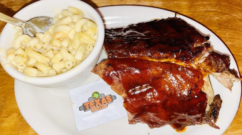 Texas Roadhouse Killer Ribs with a cup of mac and cheese are shown.
