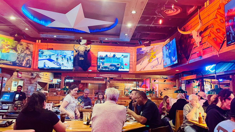A busy Texas Roadhouse dining room is filled with customers.