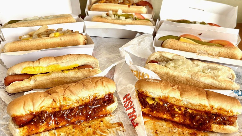 A group of different hot dogs sitting on their packaging