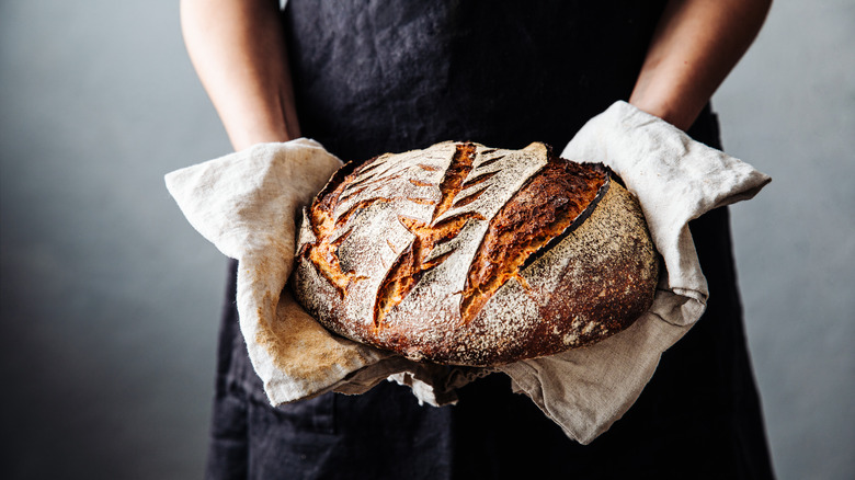 Man holding loaf of bread