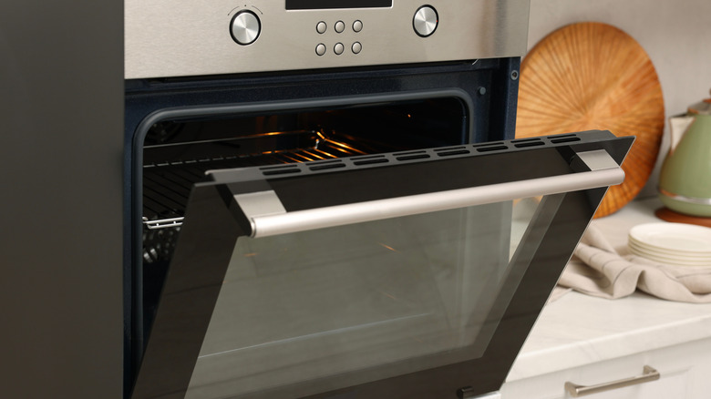 A sleek oven with its door slightly ajar