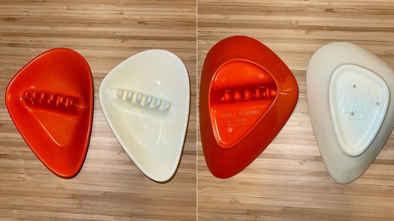 Side by side photos of a red and white Anholt Atomic Boomerang Ashtrays, right side up and flipped over.