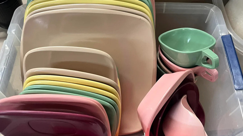 A crate filled with colorful Melmac dishes