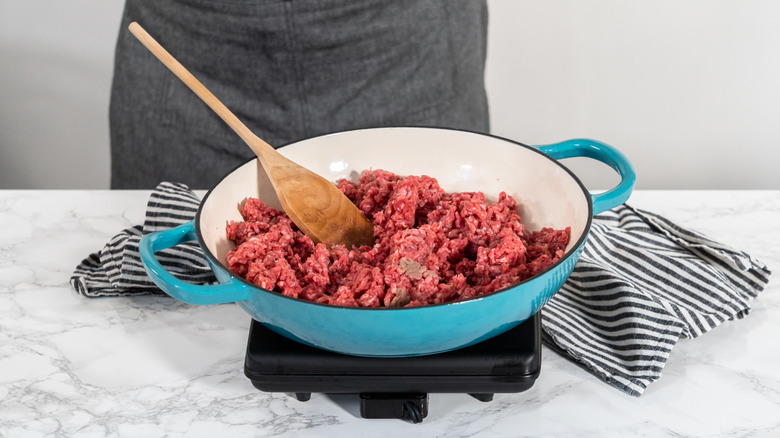 Browning ground beef in cast iron skillet to make homemade hamburger helper