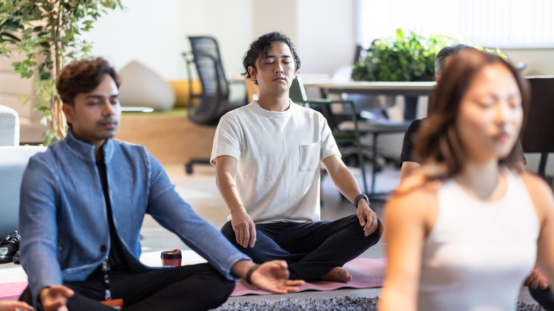 people sitting on floor meditating