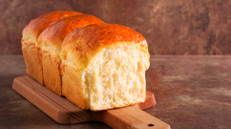 A loaf of Japanese milk bread on a cutting board