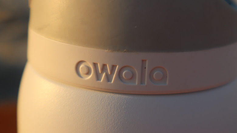 A close-up of an Owala bottle, mainly showing its logo.