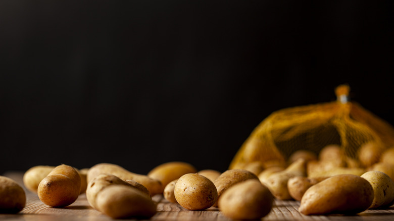 Potatoes spilled from mesh bag