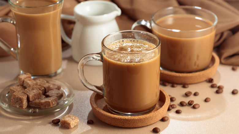 Brown sugar lattes are arranged near dishes of brown sugar cubes.