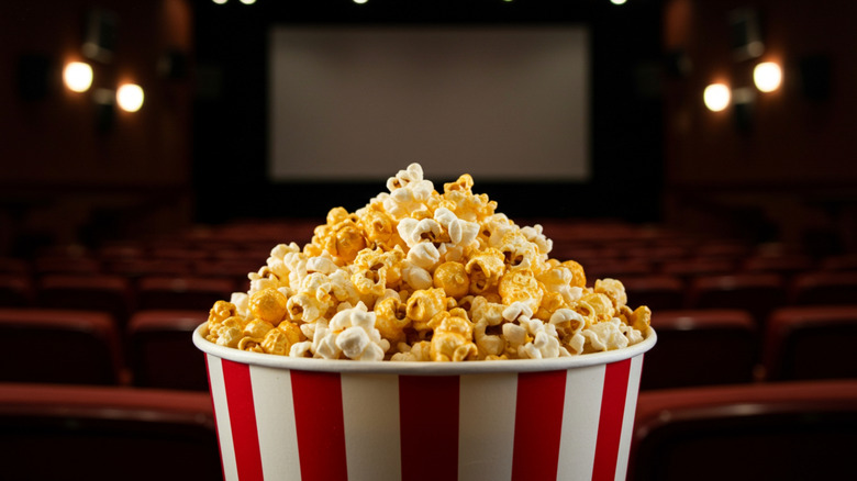 dark movie theater with popcorn bucket in the foreground