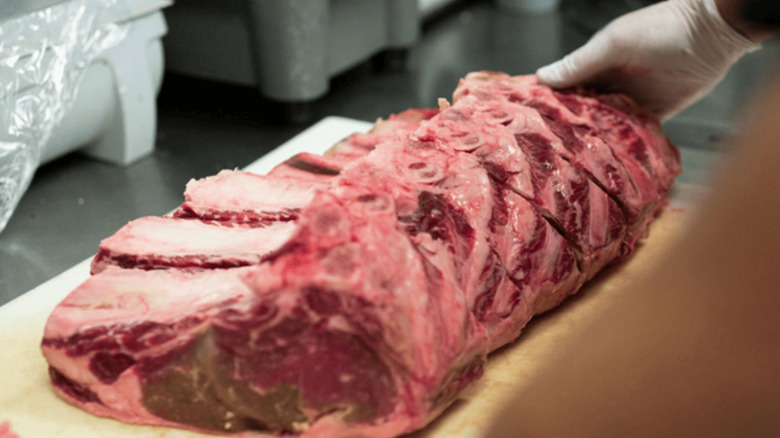 racks of raw meat on a cutting board at The Prime Rib