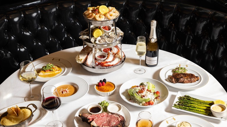 Assorted meats, veggies, desserts, and drinks on a table at The Prime Rib in Baltimore