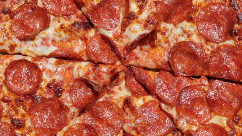 The center of a pepperoni pizza sliced and ready for eating.
