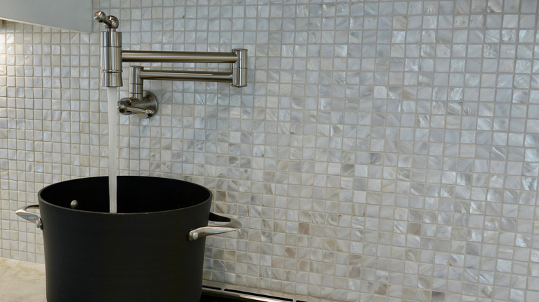 pot filler dispensing water into a pot