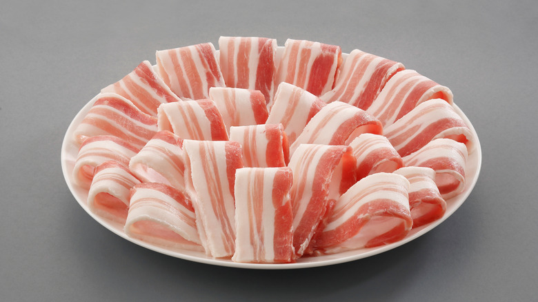 Slices of pork belly on plate