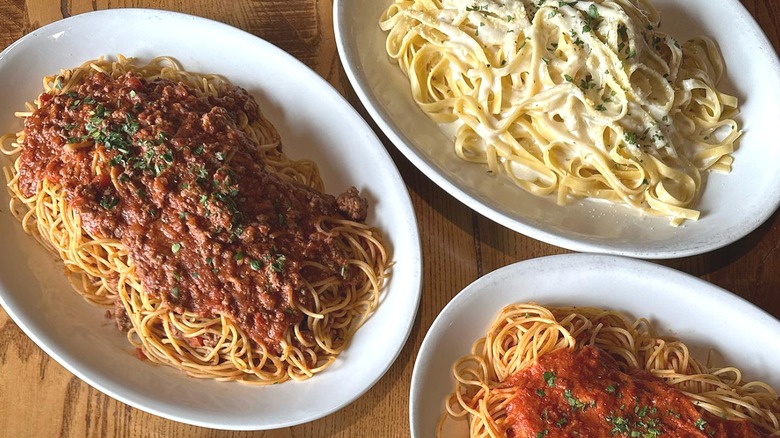 Plates of pasta on table