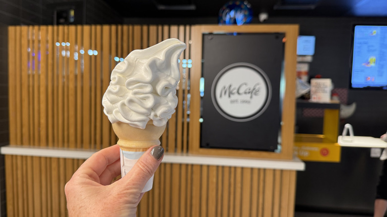 Hand holding McDonald's vanilla soft serve cone