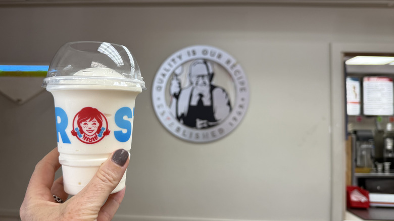Hand holding a vanilla frosty at Wendy's