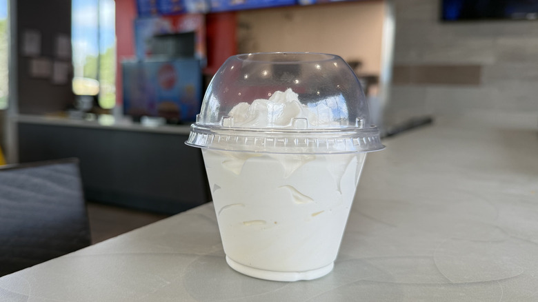 cup of vanilla soft serve on table at sonic