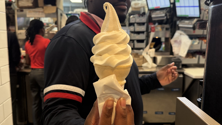 server handing over vanilla cone at Chick-fil-A
