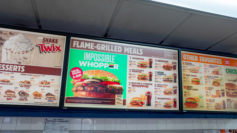 Several panels of Burger King's menu above a service counter.