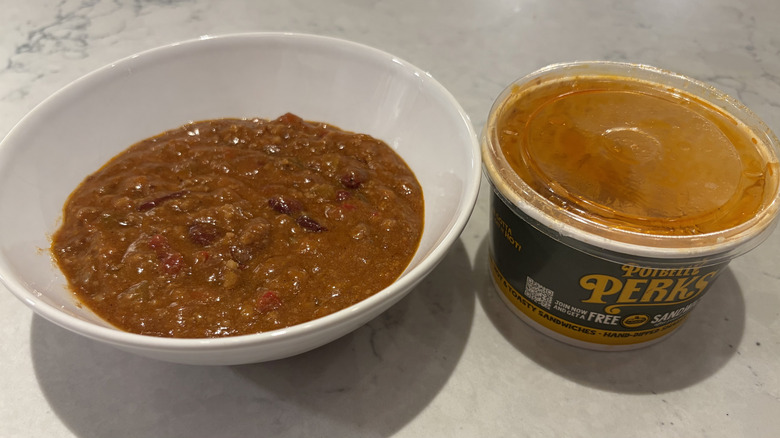 A bowl of chili from Potbelly next to its original container