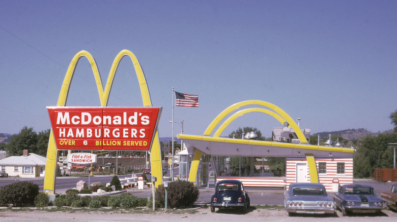 The outside of a McDonald's drive thru in the 1970s.
