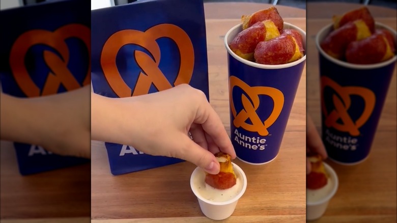 Someone dipping Auntie Anne's pepperoni pretzel nuggets into a Hidden Valley Ranch sauce