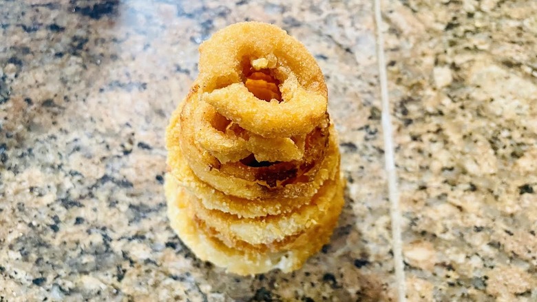 Stack of onion rings on marble counter