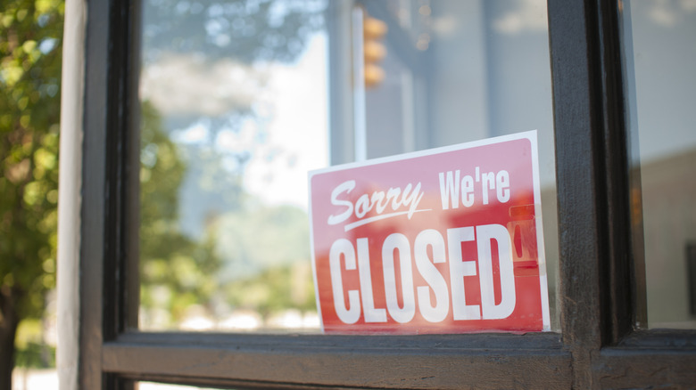 Restaurant location with a closed sign on door
