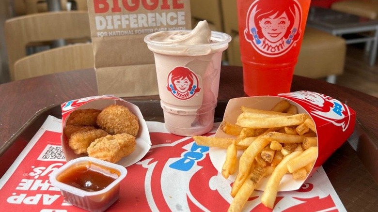 Tray of Wendy's food including nuggets, fries, and a Frosty