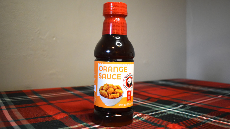 bottle of orange sauce on a table