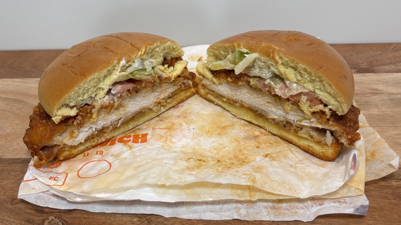 Burger King Spicy Royal Crispy Chicken Sandwich cut in half on greasy wrapper