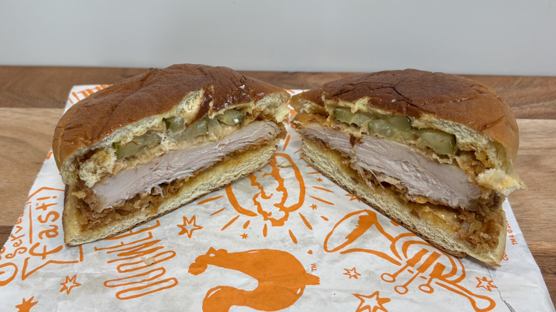 Popeyes Spicy Chicken Sandwich cut in half on wrapper